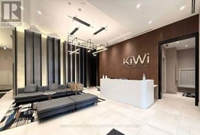Hamilton (Beasley) condo for rent - A modern office lobby with a reception desk and a large glass partition.