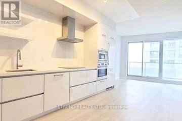 Toronto (Mount Pleasant West) condo for rent - A modern kitchen with white cabinets and appliances.