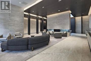 Toronto (Mount Pleasant West) condo for rent - A modern living room with a grey sofa and a wooden floor.