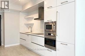 Toronto (Mount Pleasant West) condo for rent - A modern kitchen with white cabinets and stainless steel appliances.