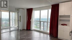 Toronto (Bendale) condo for rent - A room with a large window and red curtains.