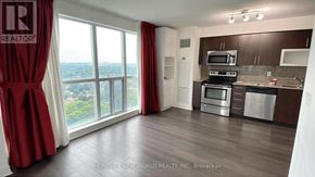 Toronto (Bendale) condo for rent - A well-lit kitchen with a view of the cityscape outside the window.