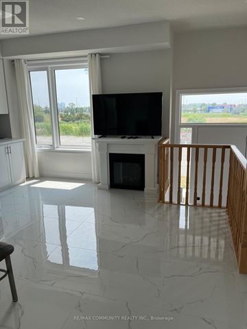 Vaughan (Vellore Village) townhouse for rent - A living room with a television and a fireplace.