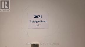 Oakville (Jm Joshua Meadows) condo for rent - A sign on a wall that says 3071 Trafalgar Road.