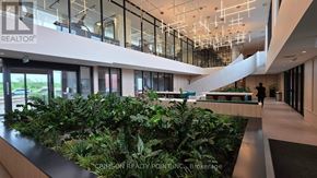 Oakville (Jm Joshua Meadows) condo for rent - A modern office space with a green indoor plant area.