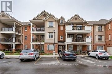 Oakville (Ro River Oaks) townhouse for rent - A row of apartment buildings with cars parked in front.
