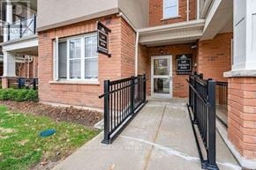 Oakville (Ro River Oaks) townhouse for rent - A brick building with a black railing in front.