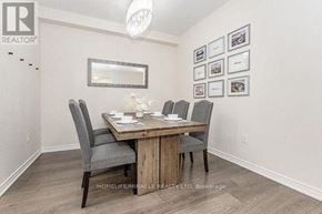 Oakville (Ro River Oaks) townhouse for rent - A dining room with a wooden table and chairs.