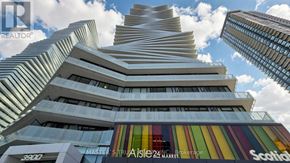 Mississauga (City Centre) condo for rent - A tall building with a curved facade and a sign that reads "Scotts".