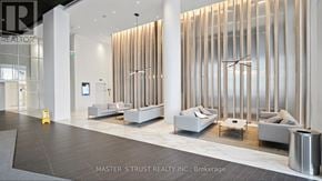 Mississauga (City Centre) condo for rent - A realtor's office with a white reception desk and a white sofa.