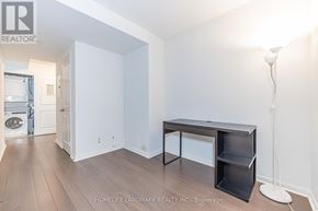 Toronto (Bay Street Corridor) condo for rent - A room with a desk and a floor lamp.