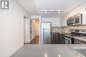 Toronto (Bay Street Corridor) condo for rent - A kitchen with a refrigerator, oven, and microwave.