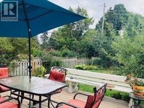 Markham (Grandview) apartment for rent - A patio with a table and chairs under a blue umbrella.