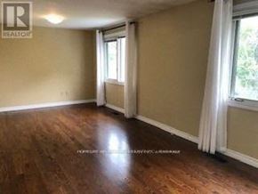 Markham (Grandview) apartment for rent - A room with wooden flooring and a window with white curtains.