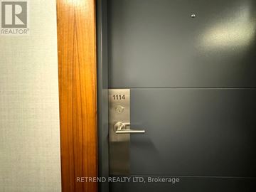 Toronto (Moss Park) condo for rent - A door with a handle and a lock is shown with the number 1114 on it.