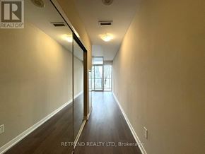 Toronto (Moss Park) condo for rent - A long hallway with a door at the end.