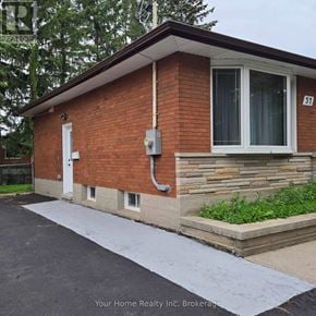 Kitchener apartment for rent - A small brick building with a white door and windows.