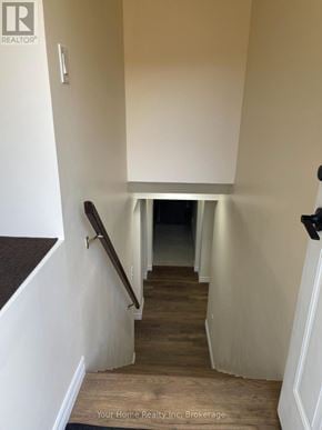 Kitchener apartment for rent - A hallway with a staircase leading to a dark room.
