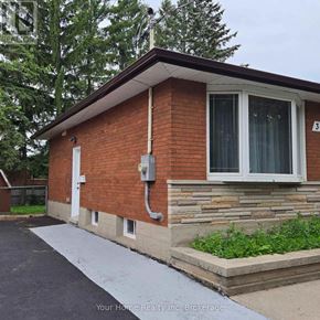 Kitchener apartment for rent - A red brick house with a heat pump outside.