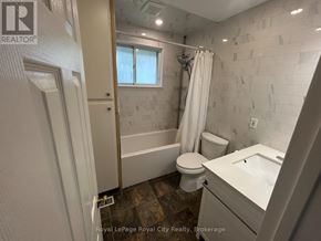 Guelph (Victoria North) apartment for rent - A bathroom with a white tub, toilet, and sink.