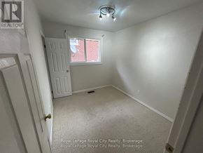 Guelph (Victoria North) apartment for rent - A white bedroom with a window and a door.