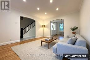 Ottawa apartment for rent - A living room with a couch, a coffee table, and a lamp.