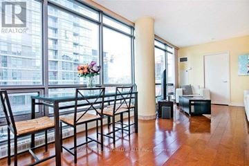 Toronto (Waterfront Communities) condo for rent - A living room with a dining table and chairs.