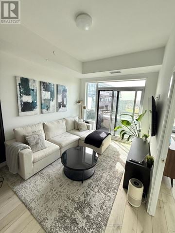 Oakville (Go Glenorchy) condo for rent - A living room with a grey couch and a black coffee table.