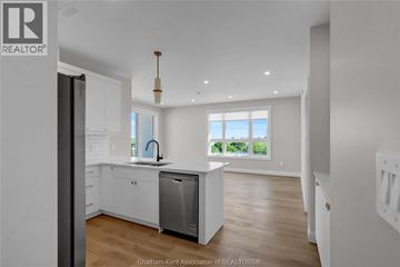 Blenheim apartment for rent - A modern kitchen with white cabinets and a large window.