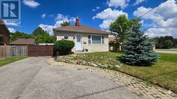London East (East O) apartment for rent - A house with a driveway and a tree in front of it.