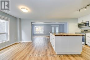 Cambridge apartment for rent - A well-lit kitchen with wooden floors and white cabinets.