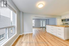Cambridge apartment for rent - A well-lit, spacious kitchen with wooden floors and white cabinetry.