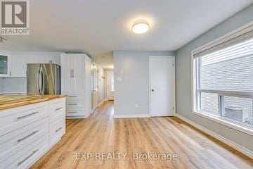 Cambridge apartment for rent - A kitchen with white cabinets and a wooden floor.