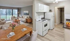 Surrey apartment for rent - A modern kitchen with a wooden table and chairs in the foreground.