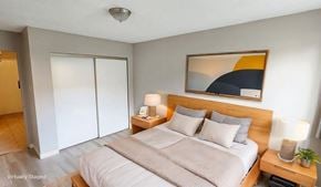 Surrey apartment for rent - A bedroom with a bed, nightstand, and a painting on the wall.