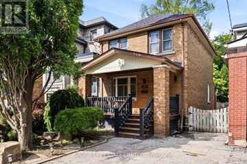 Toronto (East York) apartment for rent - A house with a brick facade and a black metal staircase.
