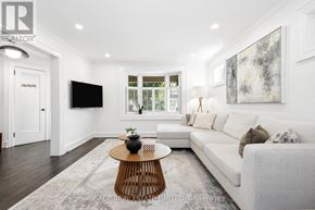 Toronto (East York) apartment for rent - A modern living room with a white couch and a wooden coffee table.