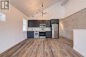 Toronto (The Beaches) multi-family for rent - A kitchen with a washer and dryer built in.