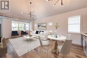Toronto (The Beaches) multi-family for rent - A modern living room with a dining table set up with white chairs.