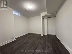 Georgina (Keswick North) apartment for rent - A room with wooden flooring and white walls, with a doorway leading to another room.