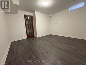 Georgina (Keswick North) apartment for rent - A room with wooden flooring and a door at the end.