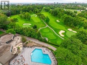 Toronto (Markland Wood) condo for rent - A golf course with a pool and a building in the foreground.