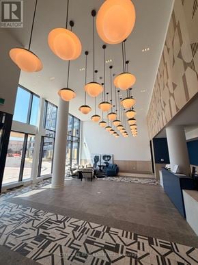 Burlington (Alton) condo for rent - A large room with a lot of hanging lights.