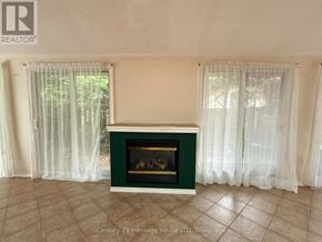 Niagara Falls (West Wood) apartment for rent - A fireplace in a room with a green mantle and white curtains.