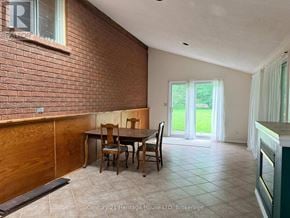 Niagara Falls (West Wood) apartment for rent - A dining room with a brick wall and a table set for four.