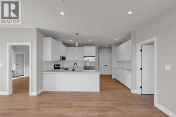 Blenheim apartment for rent - A modern kitchen with white cabinets and a central island.