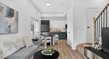 North York apartment for rent - A modern living room with a grey sofa and a black coffee table.