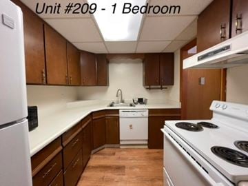 Longview apartment for rent - A kitchen with brown cabinets and white appliances.