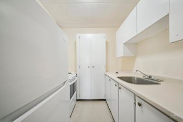 Sault Ste. Marie apartment for rent - A white kitchen with a sink and a refrigerator.
