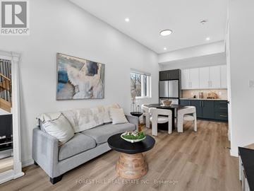 North York apartment for rent - A living room with a grey couch and a painting of a white animal on the wall.
